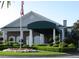 Elegant clubhouse exterior with landscaping and flag at 5405 Fair Oaks St # 5405, Bradenton, FL 34203