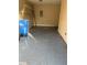 Garage with blue recycling bin and speckled floor at 5405 Fair Oaks St # 5405, Bradenton, FL 34203