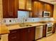 Modern kitchen with granite countertops and wood cabinets at 5405 Fair Oaks St # 5405, Bradenton, FL 34203