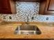 Granite countertop kitchen with a stylish backsplash and sink at 5405 Fair Oaks St # 5405, Bradenton, FL 34203