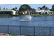 Tranquil lake view with fountain and houses in background at 5405 Fair Oaks St # 5405, Bradenton, FL 34203