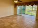 Spacious living room with tile floors and access to a patio at 5405 Fair Oaks St # 5405, Bradenton, FL 34203