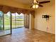 Bright living room with tile floors and sliding glass doors leading to a balcony overlooking a golf course at 5405 Fair Oaks St # 5405, Bradenton, FL 34203