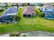 Aerial view of home's backyard, highlighting its expansive lawn and lake view at 7926 111Th E Ter, Parrish, FL 34219