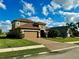 Two-story house with tan exterior, brown roof, and a two-car garage at 7926 111Th E Ter, Parrish, FL 34219