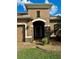 Front door entry with stone accents and arched entryway at 7926 111Th E Ter, Parrish, FL 34219