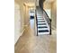 View of staircase from hallway, dark wood and white risers at 7926 111Th E Ter, Parrish, FL 34219