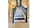 Elegant staircase with dark wood and white risers at 7926 111Th E Ter, Parrish, FL 34219