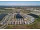 Aerial view of a community featuring a lake and numerous houses at 8372 Sea Glass Ct, Sarasota, FL 34240