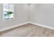 Empty bedroom with neutral walls and wood-look floors at 8372 Sea Glass Ct, Sarasota, FL 34240