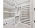 Bright white closet with double hanging rods and drawers at 8372 Sea Glass Ct, Sarasota, FL 34240