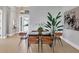 Modern dining area with glass top table and six leather chairs at 8372 Sea Glass Ct, Sarasota, FL 34240