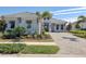 Gray house with a three-car garage and palm trees at 8372 Sea Glass Ct, Sarasota, FL 34240