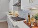 White kitchen with gas cooktop, quartz countertops and gold accents at 8372 Sea Glass Ct, Sarasota, FL 34240