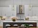 Bright kitchen with white cabinets, geometric backsplash and a large island at 8372 Sea Glass Ct, Sarasota, FL 34240