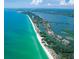 Aerial view showing coastal community, beach, and waterways at 9393 Midnight Pass Rd # 201, Sarasota, FL 34242