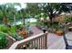 Landscaped backyard with brick patio and waterfront access at 9393 Midnight Pass Rd # 201, Sarasota, FL 34242