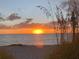 Stunning sunset view over the ocean from the beach at 9393 Midnight Pass Rd # 201, Sarasota, FL 34242