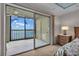 Bedroom with balcony access and water views at 9393 Midnight Pass Rd # 201, Sarasota, FL 34242