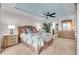 Main bedroom with a view, ceiling fan and large windows at 9393 Midnight Pass Rd # 201, Sarasota, FL 34242