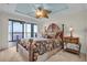 Main bedroom with water views and a wooden canopy bed at 9393 Midnight Pass Rd # 201, Sarasota, FL 34242