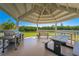 Relaxing gazebo with picnic tables and grill overlooking the water at 9393 Midnight Pass Rd # 201, Sarasota, FL 34242