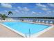 Inviting community pool with plenty of lounge chairs at 9393 Midnight Pass Rd # 201, Sarasota, FL 34242