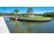 Waterfront gazebo with seating area and lush landscaping at 9393 Midnight Pass Rd # 201, Sarasota, FL 34242