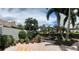 Lovely courtyard with tropical plants and a stone path at 9393 Midnight Pass Rd # 201, Sarasota, FL 34242