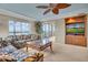 Living area features sliding doors to balcony and a large TV at 9393 Midnight Pass Rd # 201, Sarasota, FL 34242