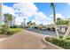 Covered parking area with paver walkway and landscaping at 9393 Midnight Pass Rd # 201, Sarasota, FL 34242