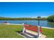 Serene waterfront view with benches and lush greenery at 9393 Midnight Pass Rd # 201, Sarasota, FL 34242