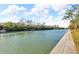 Scenic canal-front view with lush vegetation and walkways at 9393 Midnight Pass Rd # 201, Sarasota, FL 34242