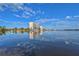 Kayakers paddle in calm waters with condo building reflection at 9393 Midnight Pass Rd # 201, Sarasota, FL 34242