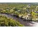 Aerial view of riverfront property with lush vegetation at 1285 & 1289 Hagle Park Rd, Bradenton, FL 34212