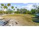 Sunny boat launch area with grassy banks and palm trees at 1285 & 1289 Hagle Park Rd, Bradenton, FL 34212