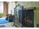 Ornate fireplace with metal screen and wood storage at 1285 & 1289 Hagle Park Rd, Bradenton, FL 34212