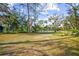 Spacious front yard with lush landscaping and mature trees at 1285 & 1289 Hagle Park Rd, Bradenton, FL 34212