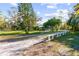 Gravel driveway leads to a home with a spacious yard at 1285 & 1289 Hagle Park Rd, Bradenton, FL 34212