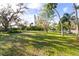 Landscaped yard with mature trees and houses visible in the background at 1285 & 1289 Hagle Park Rd, Bradenton, FL 34212