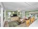 Living room with green walls, tile floors, and a cozy seating area at 1285 & 1289 Hagle Park Rd, Bradenton, FL 34212