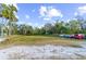 Parking area with grassy lawn and fire pit at 1285 & 1289 Hagle Park Rd, Bradenton, FL 34212