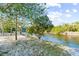 Picturesque riverfront lot with sandy bank and signage at 1285 & 1289 Hagle Park Rd, Bradenton, FL 34212