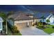 Night-time aerial view of house, showcasing the home's architecture and landscaping at 13325 Indigo Way, Bradenton, FL 34211