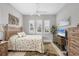 Guest bedroom with a queen bed, window seating, and a TV at 13325 Indigo Way, Bradenton, FL 34211