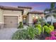 Two-story house with two-car garage, landscaping, and palm trees at 13325 Indigo Way, Bradenton, FL 34211