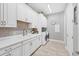 Bright laundry room featuring white cabinets and tile floors at 13325 Indigo Way, Bradenton, FL 34211