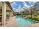 Spacious pool and patio with screened enclosure and lush landscaping at 13325 Indigo Way, Bradenton, FL 34211