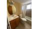 Clean bathroom with wood vanity, oval mirror, and shower/tub combo at 2227 Sunset Dr # E-22, Bradenton, FL 34207