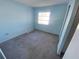 Second bedroom with gray carpet and light blue walls at 2227 Sunset Dr # E-22, Bradenton, FL 34207